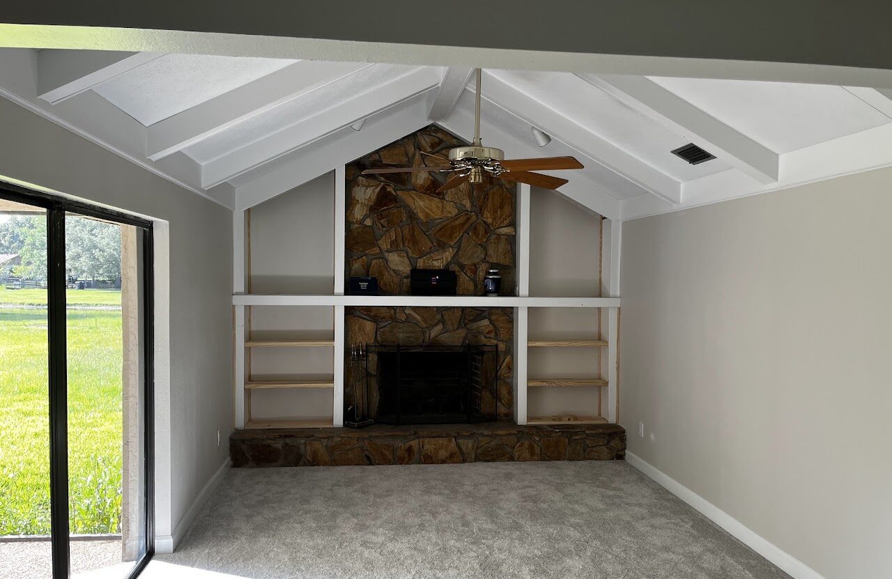 Completed living room renovation with stone fireplace and custom built-ins by Bay Area Constructors